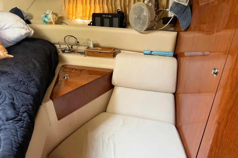 Slide: The Image of Interior of 2005 Regal Commodore 3560 yacht with cozy seating and wooden accents. - 27
