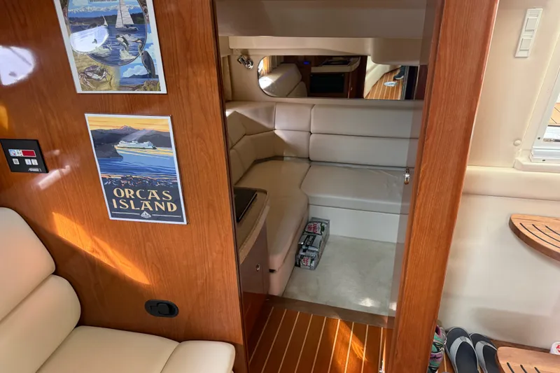 Slide: The Image of Interior of 2005 Regal Commodore 3560 yacht with cozy seating and Orcas Island poster. - 34