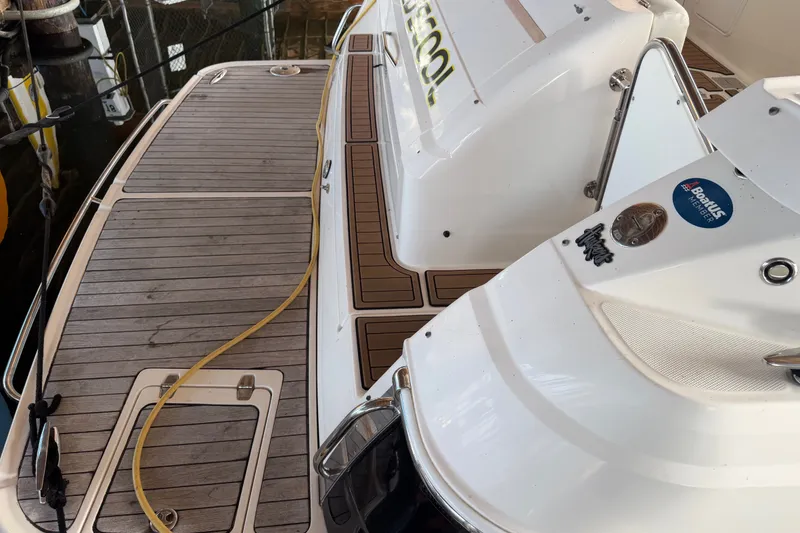 Slide: The Image of 2005 Regal Commodore 3560 yacht deck with wood finish and docked at marina. - 48