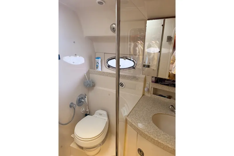 Slide: The Image of Bathroom interior of 2005 Regal Commodore 3560 yacht, featuring toilet and sink. - 33