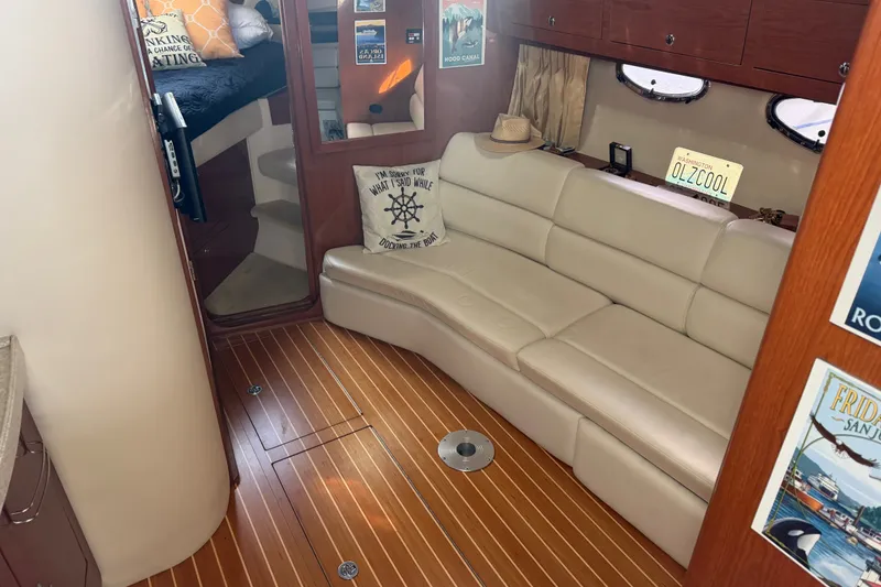 Slide: The Image of Interior of 2005 Regal Commodore 3560 yacht with beige leather seating and wooden flooring. - 17