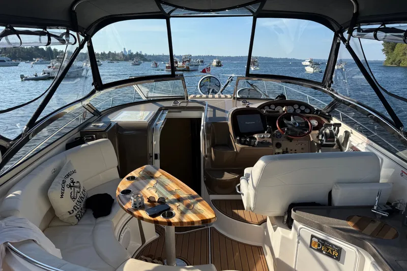 Slide: The Image of Cockpit view of 2005 Regal Commodore 3560 yacht on a sunny day, surrounded by boats. - 3