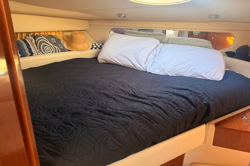 Slide: The Image of Cozy cabin interior of 2005 Regal Commodore 3560 yacht with bed and pillows. - 26