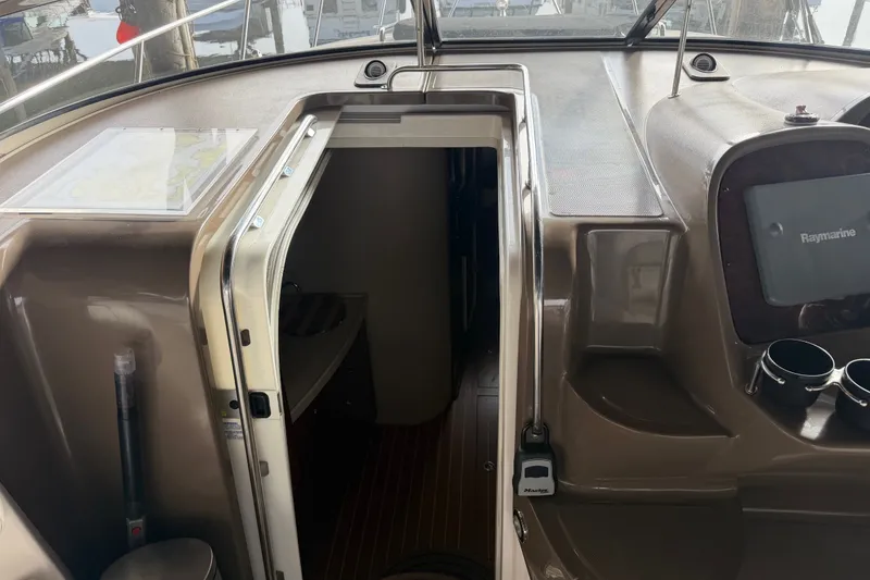 Slide: The Image of 2005 Regal Commodore 3560 yacht interior with navigation equipment and cabin entrance. - 16