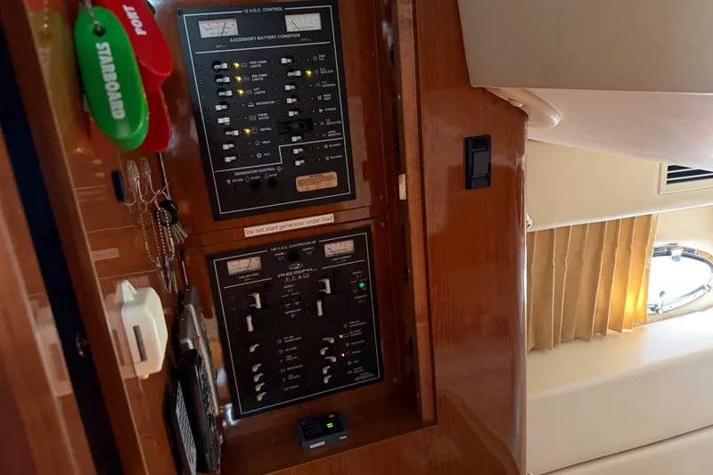 Slide: The Image of Control panel inside 2005 Regal Commodore 3560 yacht, featuring switches and key holders. - 39