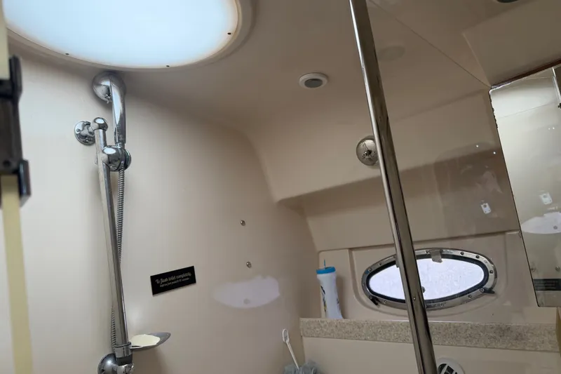 Slide: The Image of Interior of 2005 Regal Commodore 3560 yacht bathroom with shower and porthole window. - 32