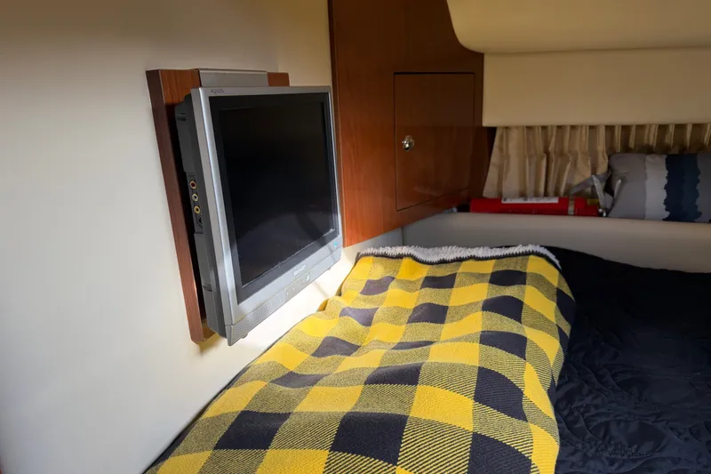 Slide: The Image of Interior of 2005 Regal Commodore 3560 with TV and checkered blanket. - 28