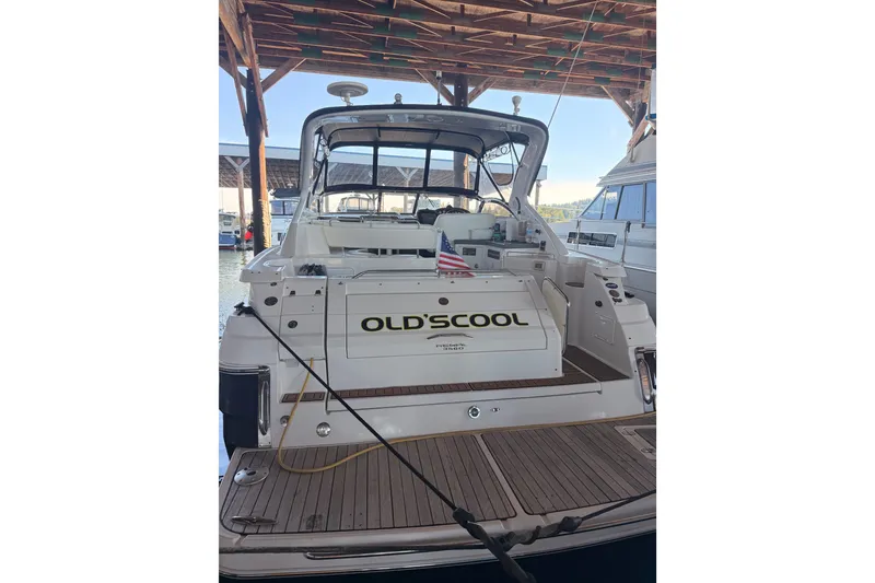 Slide: The Image of 2005 Regal Commodore 3560 yacht docked, featuring "OLD'SCOOL" name and American flag. - 49