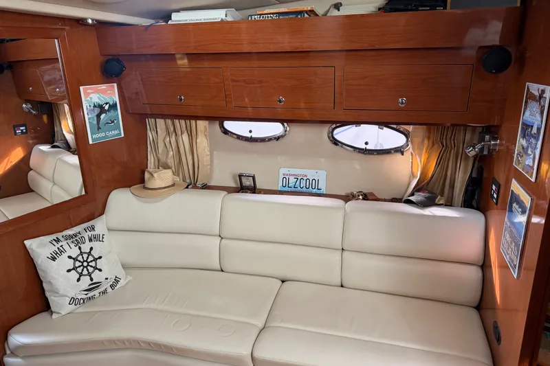 Slide: The Image of Interior of a 2005 Regal Commodore 3560 yacht with cream leather seating and wooden cabinetry. - 20