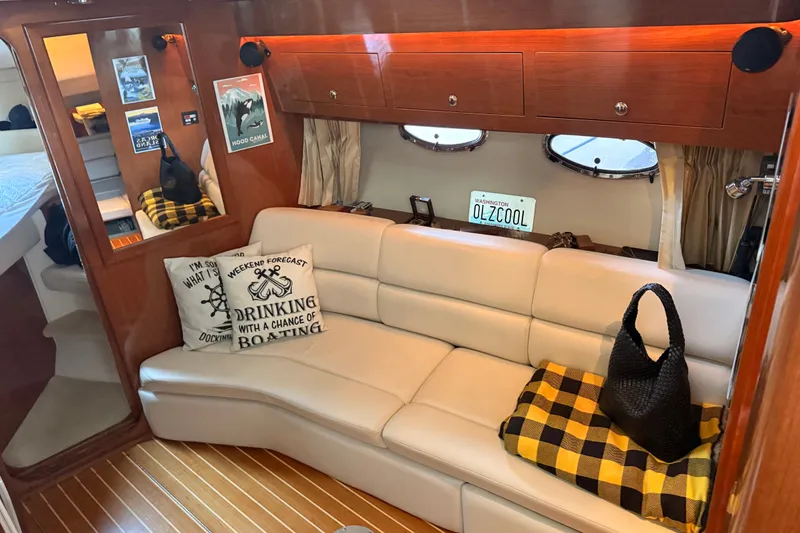 Slide: The Image of Interior of 2005 Regal Commodore 3560 yacht with cozy seating and nautical decor. - 18