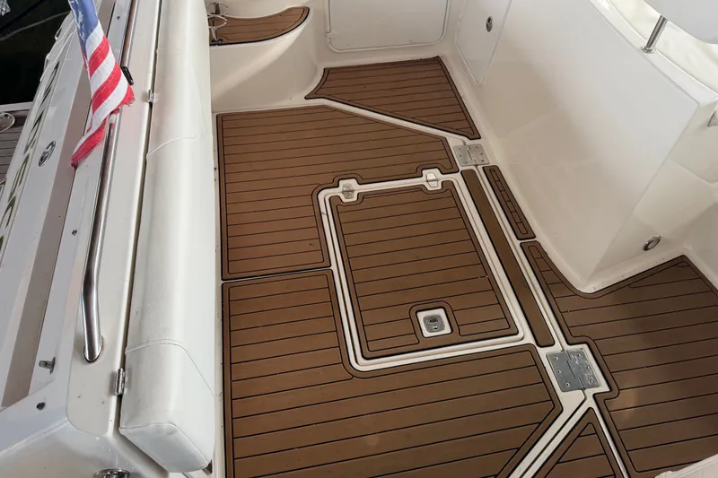 Slide: The Image of 2005 Regal Commodore 3560 boat deck with teak flooring and American flag. - 14