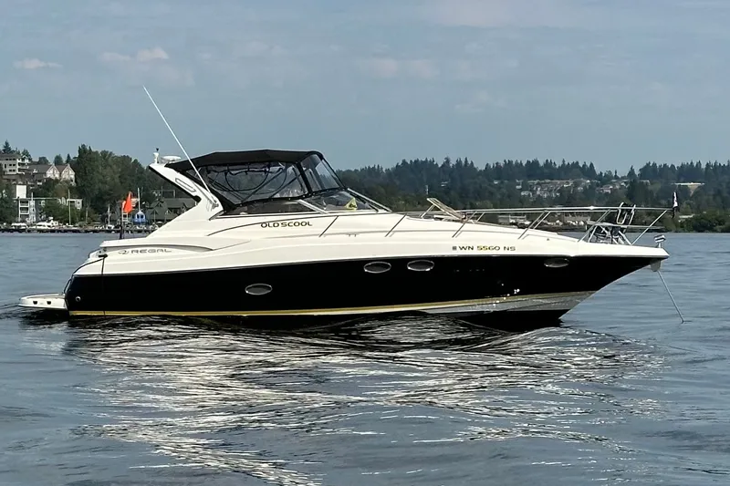 The Image of 2005 Regal Commodore 3560 yacht on calm water, with scenic background. - 0