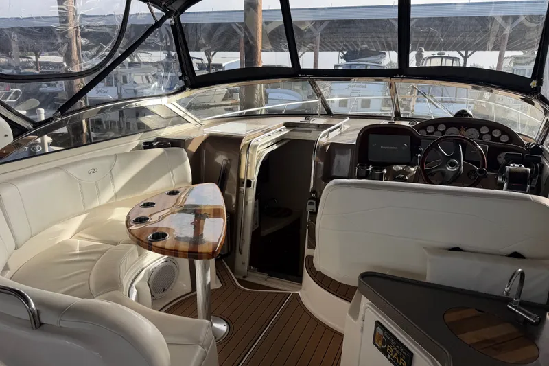 Slide: The Image of Interior of 2005 Regal Commodore 3560 yacht with helm and seating area. - 2