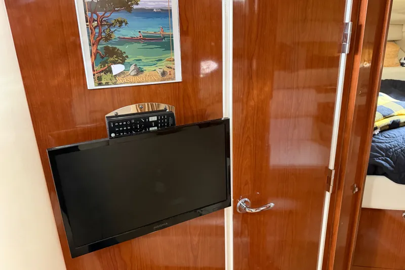 Slide: The Image of Interior of 2005 Regal Commodore 3560 with mounted TV and wooden cabinetry. - 21