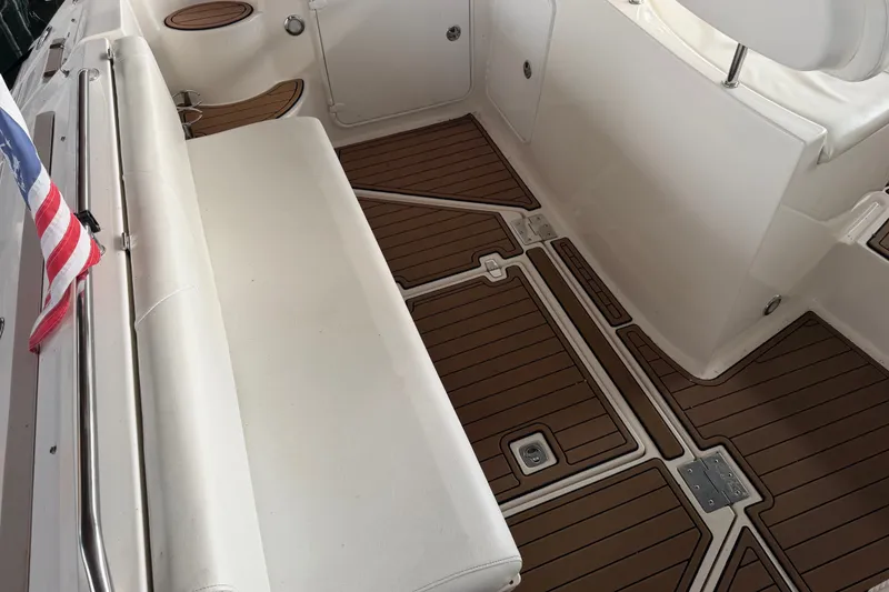 Slide: The Image of 2005 Regal Commodore 3560 boat interior with teak flooring and white seating. - 13