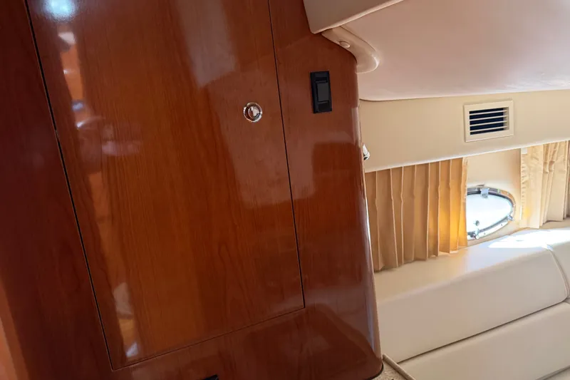 Slide: The Image of Interior of 2005 Regal Commodore 3560 yacht with wood paneling and window. - 38