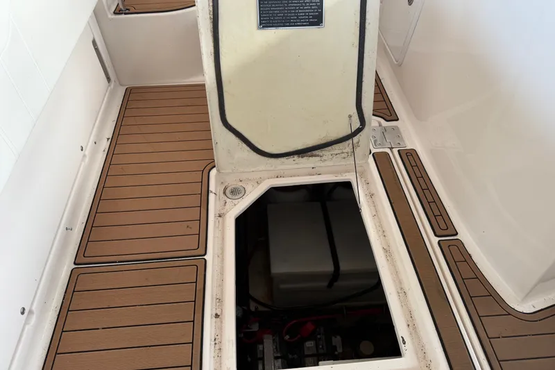 Slide: The Image of 2005 Regal Commodore 3560 boat deck with open hatch revealing storage compartment. - 40