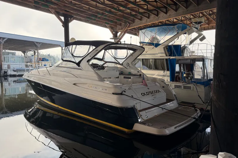 Slide: The Image of 2005 Regal Commodore 3560 yacht docked in a marina under a wooden canopy. - 52