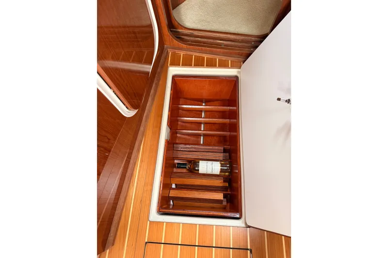 Slide: The Image of Wine storage compartment on 2005 Regal Commodore 3560 yacht with wooden flooring. - 19