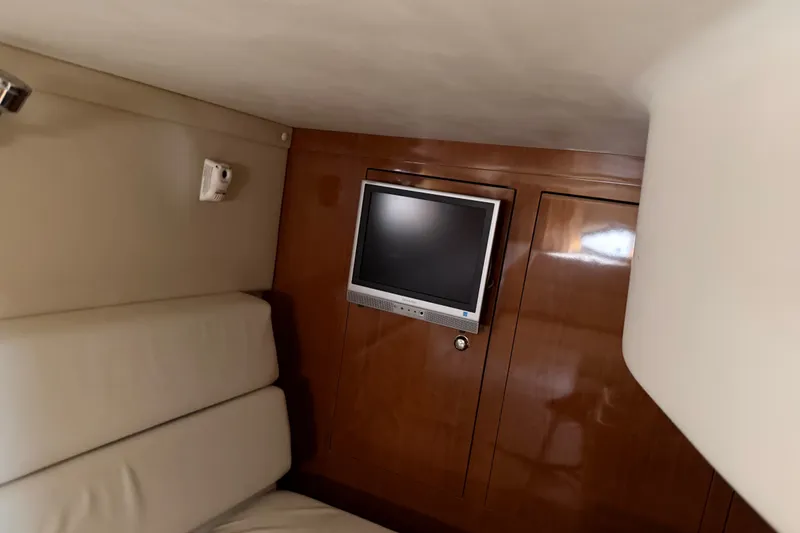 Slide: The Image of Interior of 2005 Regal Commodore 3560 yacht with TV and wooden paneling. - 37