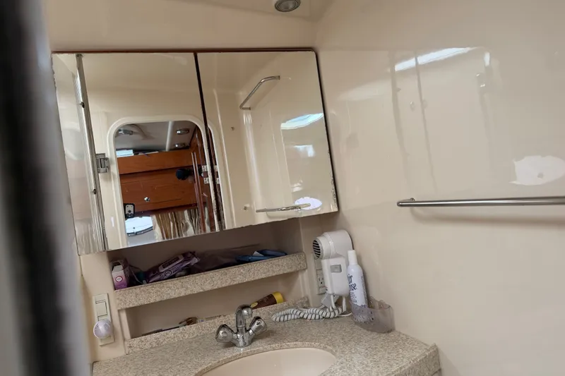 Slide: The Image of Bathroom interior of 2005 Regal Commodore 3560 yacht with mirror and sink. - 31
