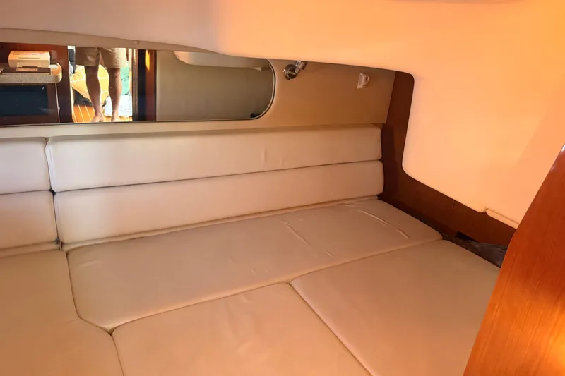 Slide: The Image of Interior cabin of 2005 Regal Commodore 3560 yacht with beige seating and mirror. - 36