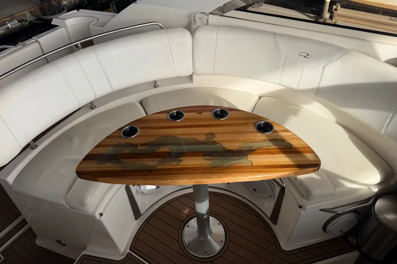 Slide: The Image of Luxurious 2005 Regal Commodore 3560 yacht interior with elegant seating and wooden table. - 9