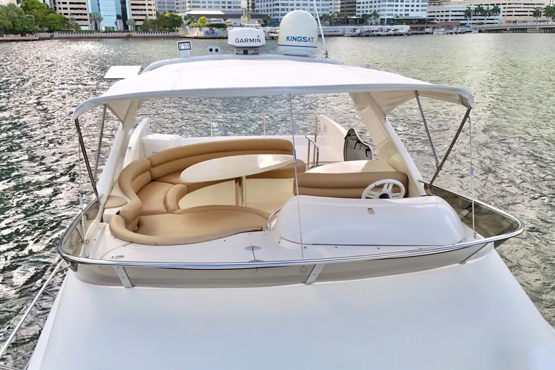 Slide: The Image of Luxurious 2007 Azimut 55E yacht with spacious seating, docked by the waterfront. - 19