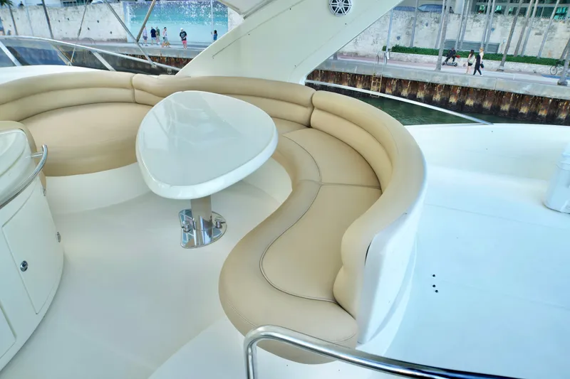 Slide: The Image of Luxurious seating area on a 2007 Azimut 55E yacht with elegant beige cushions. - 26