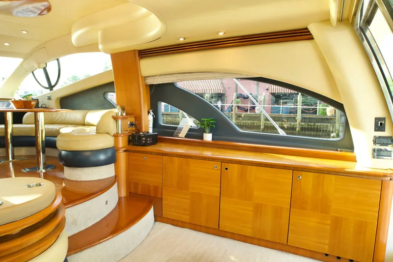 Slide: The Image of Luxurious interior of a 2007 Azimut 55E yacht with elegant wood finishes and plush seating. - 33