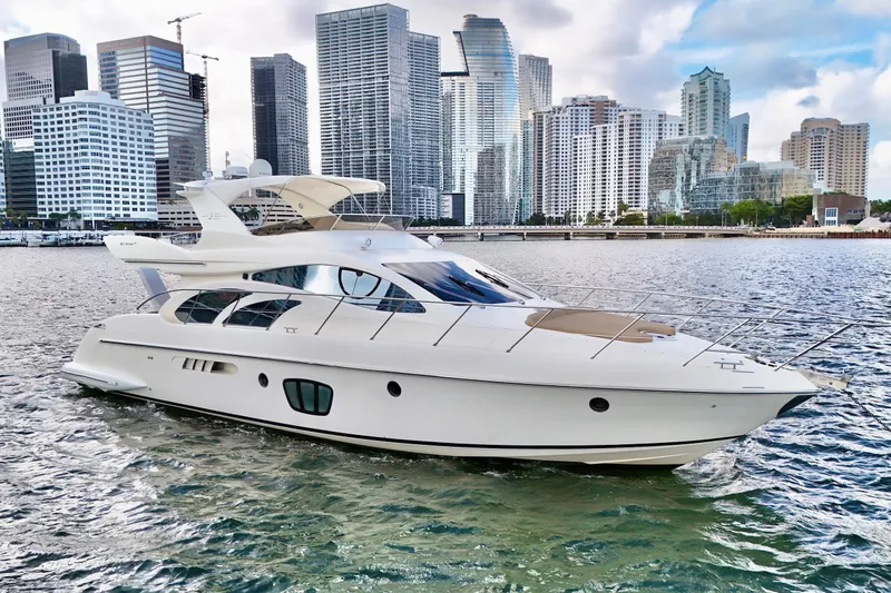 Slide: The Image of Luxurious 2007 Azimut 55E yacht cruising near a city skyline. - 3