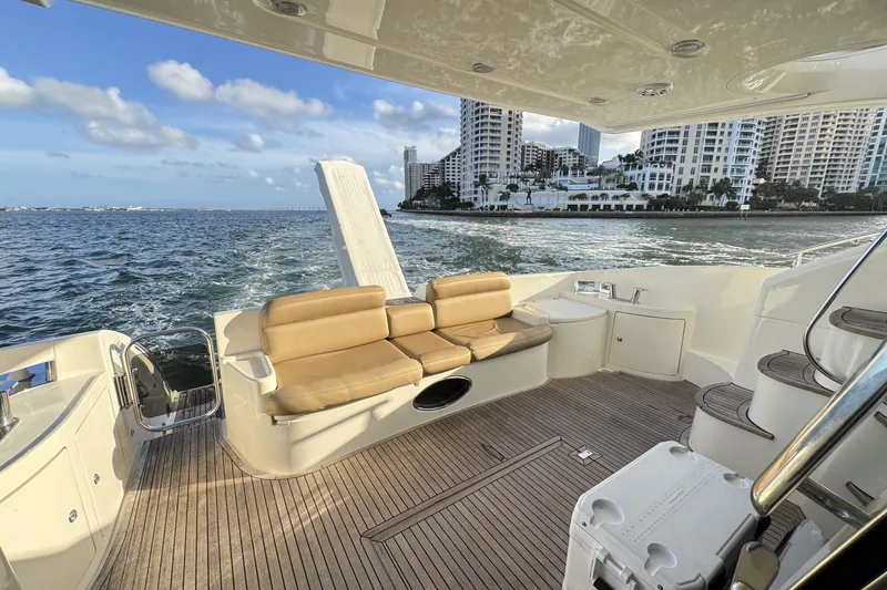 Slide: The Image of Luxurious 2007 Azimut 55E yacht deck with seating, ocean view, and city skyline. - 21