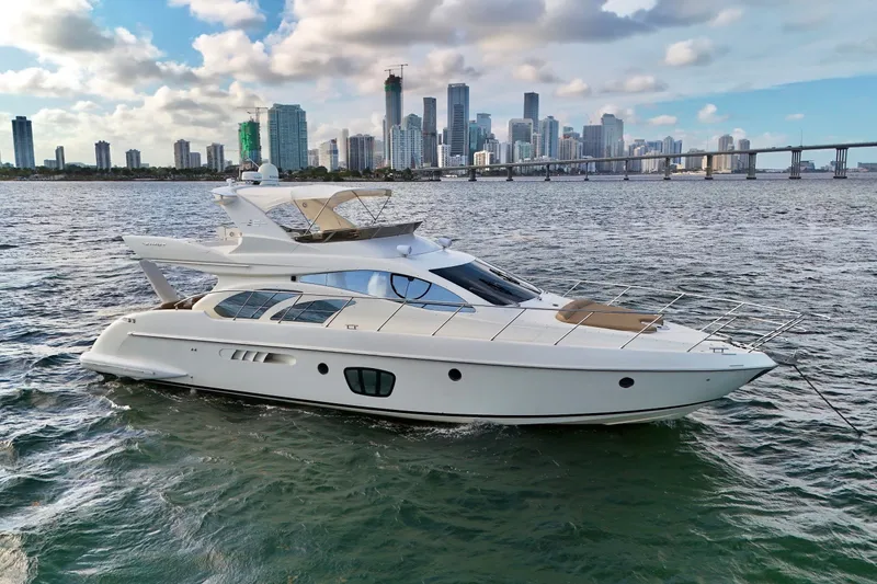 Slide: The Image of Luxury 2007 Azimut 55E yacht cruising near city skyline and bridge. - 9