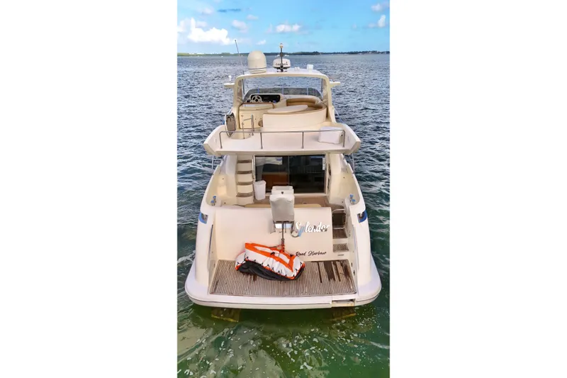 Slide: The Image of 2007 Azimut 55E yacht on water, rear view, clear sky, luxury boating. - 10