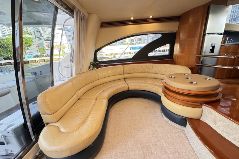 Slide: The Image of Luxurious interior of a 2007 Azimut 55E yacht with curved leather seating and modern design. - 28