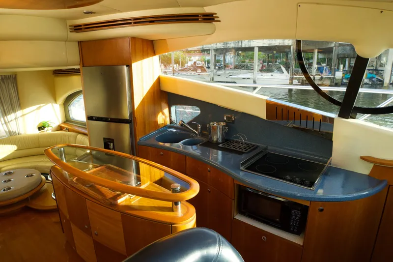 Slide: The Image of Luxurious 2007 Azimut 55E yacht interior with modern kitchen and scenic marina view. - 39