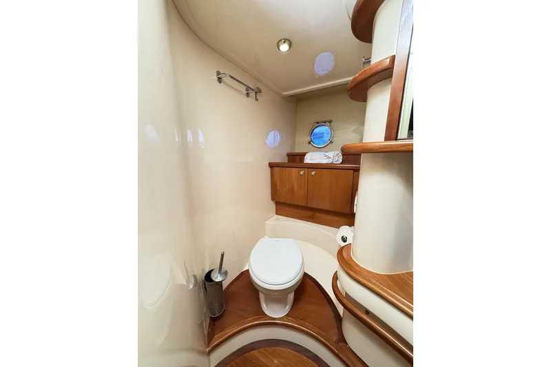 Slide: The Image of Luxurious bathroom interior of 2007 Azimut 55E yacht with wooden accents and porthole. - 44
