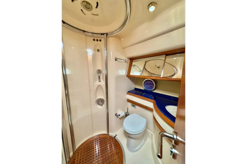 Slide: The Image of Luxurious bathroom in 2007 Azimut 55E yacht with shower, toilet, and elegant wood accents. - 46