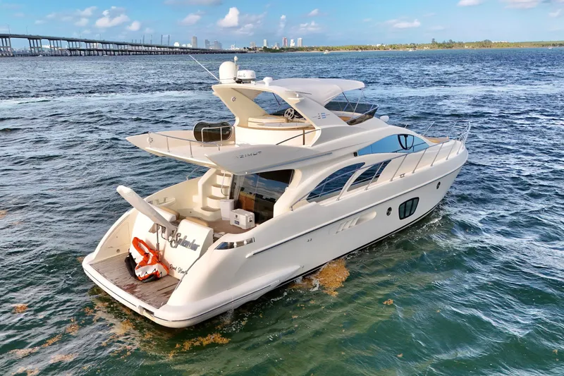 Slide: The Image of 2007 Azimut 55E yacht cruising on open water with city skyline in background. - 7