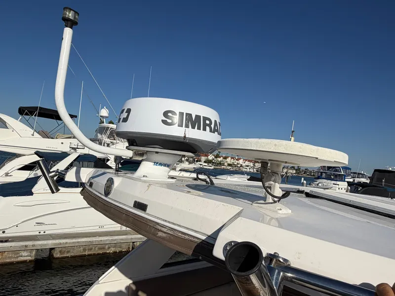 Slide: The Image of A 2013 Regal 35 Sport Coupe with Simrad radar on the roof, docked in a marina. - 23