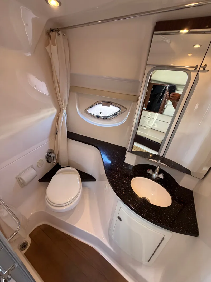 Slide: The Image of The image shows the bathroom of a 2013 Regal 35 Sport Coupe with a toilet and sink. - 14