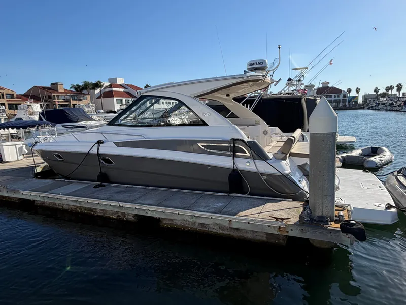 Slide: The Image of A 2013 Regal 35 Sport Coupe docked. It features sleek design and modern amenities. - 22
