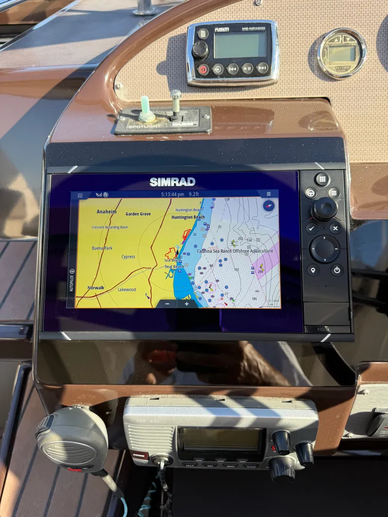 Slide: The Image of The image shows the dashboard of a 2013 Regal 35 Sport Coupe with a Simrad navigation system. - 21