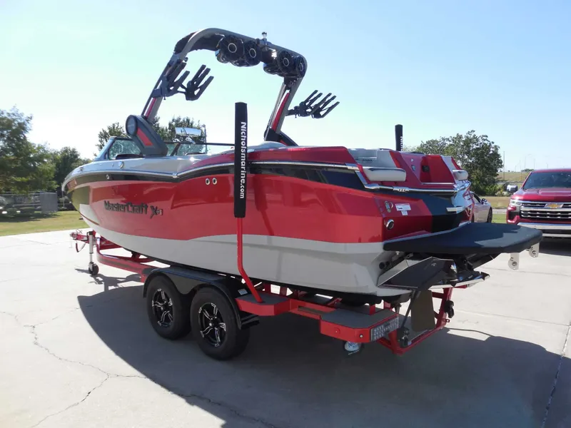 Slide: The Image of A red 2023 MasterCraft XStar S boat on a trailer, ready for use. - 5