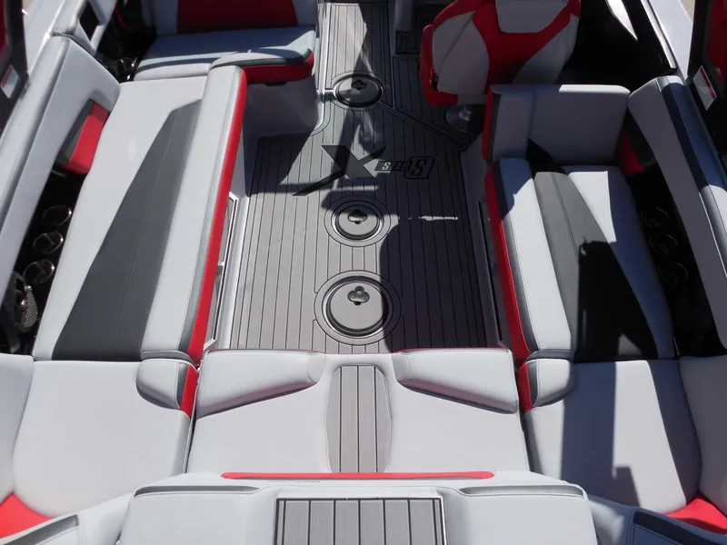 Slide: The Image of Interior of the 2023 MasterCraft XStar S with gray and red upholstery and flooring. - 16