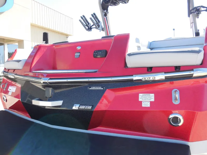 Slide: The Image of The image shows the rear of a 2023 MasterCraft XStar S boat in vibrant red. - 13