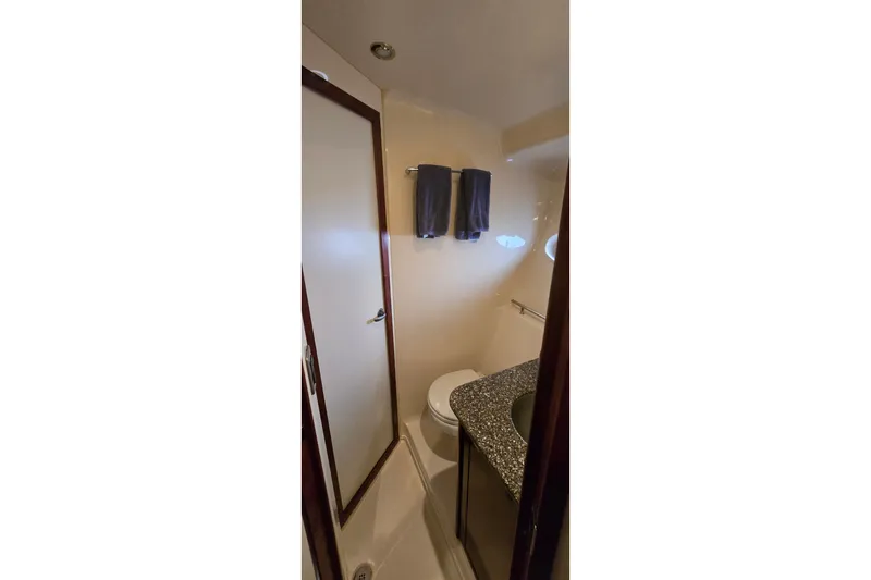 Slide: The Image of Bathroom interior of 2008 Sea Ray 38 Sundancer yacht with granite countertop and towels. - 35