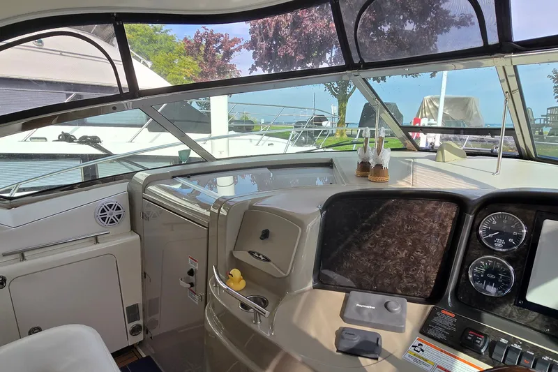 Slide: The Image of Cockpit of 2008 Sea Ray 38 Sundancer with modern controls and panoramic windows. - 18