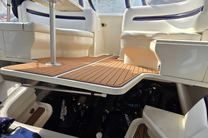 Slide: The Image of 2008 Sea Ray 38 Sundancer interior with open engine compartment, showcasing Mercury engines. - 45