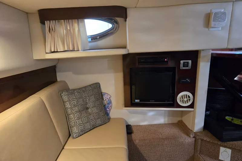 Slide: The Image of Interior of 2008 Sea Ray 38 Sundancer with TV, speaker, and beige seating. - 26